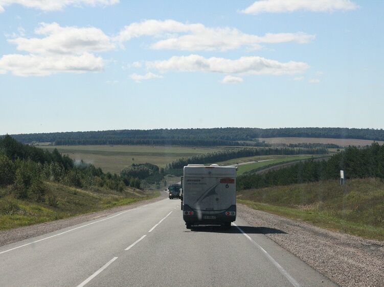 This picture, taken 10-12 years later, shows better roads in Siberia. Today there are four-lane sections. Also, because of the GPS technology, driving in a group is no longer necessary.