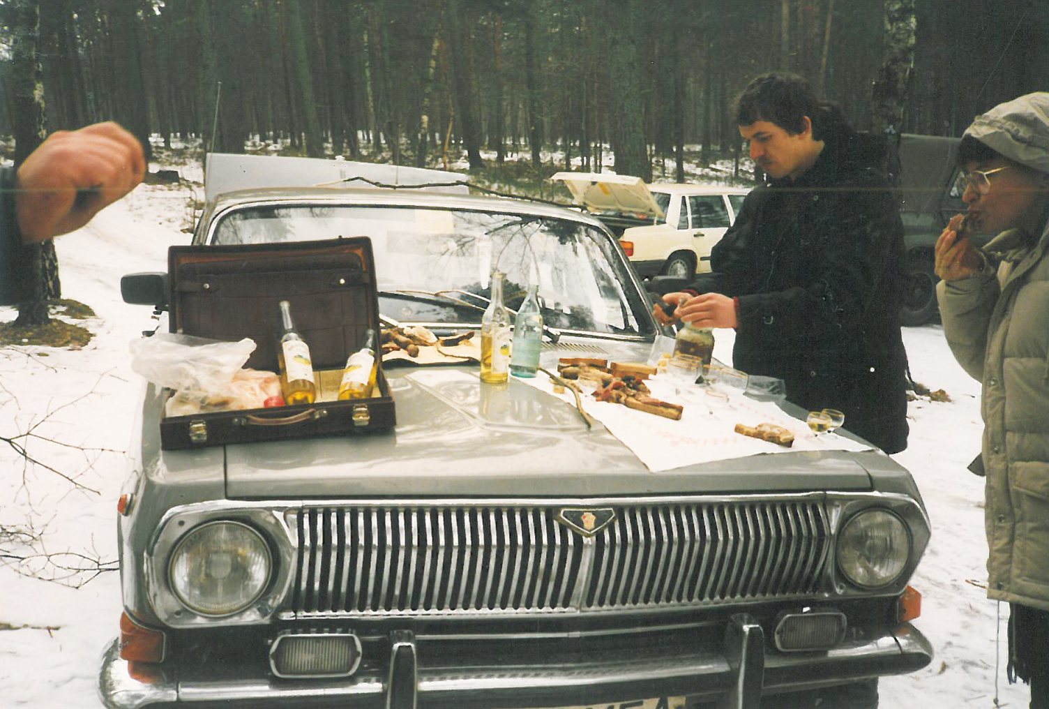 An overland business trip includes picnics and drinks. Here on Lake Naroch during one of the first visits there, before the opening of the campsite. We also went fishing on the frozen lake and ate the catch in the evening as fish soup.